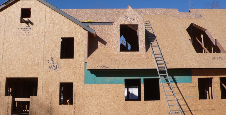 A house under construction with ACME structural insulated panels forming the walls and roof
